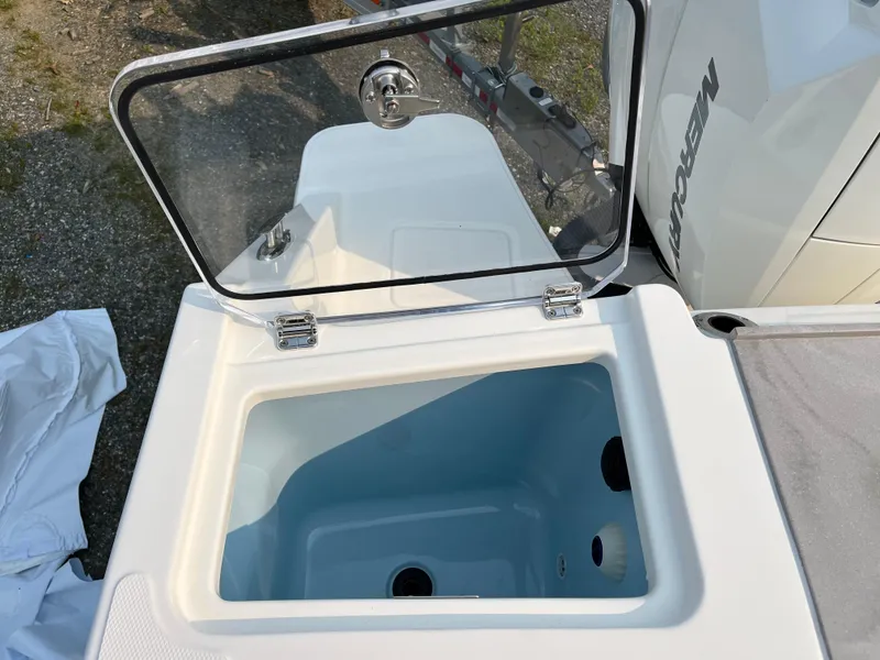 Slide: The Image of Boston Whaler 330 Vantage 2025 boat storage compartment with open lid. - 24