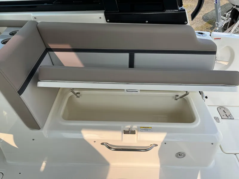 Slide: The Image of 2025 Boston Whaler 330 Vantage boat seat with storage compartment open. - 27