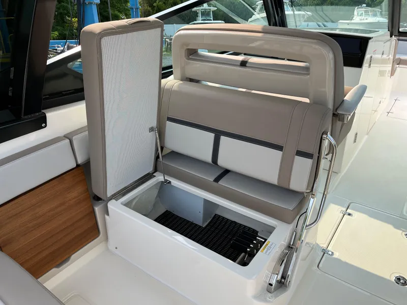 Slide: The Image of 2025 Boston Whaler 330 Vantage boat interior with open storage compartment. - 32