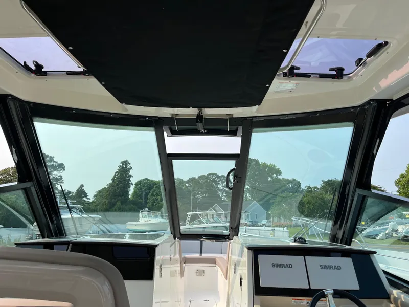 Slide: The Image of Interior view of 2025 Boston Whaler 330 Vantage boat cockpit with navigation screens. - 33