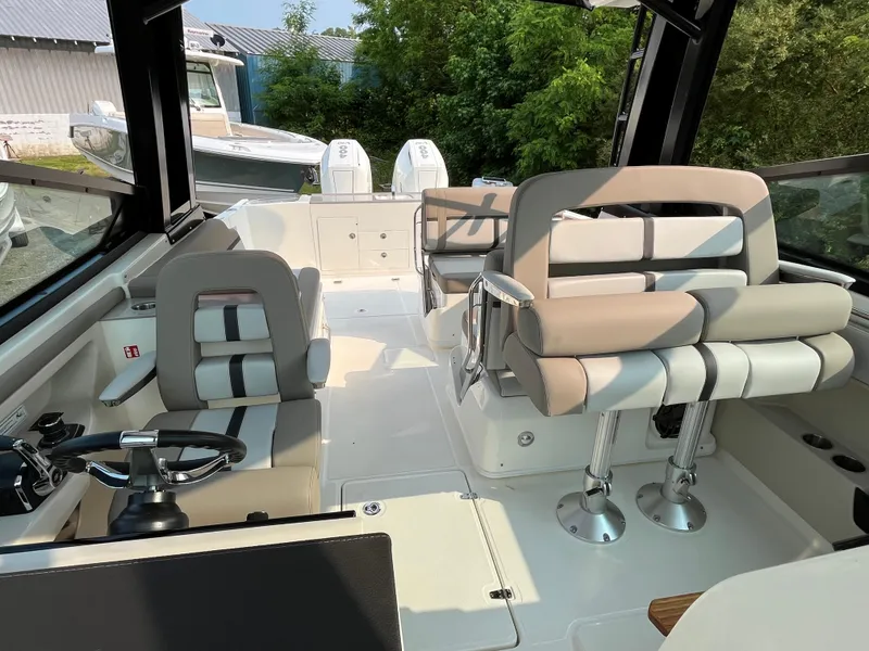 Slide: The Image of 2025 Boston Whaler 330 Vantage boat interior with modern seating and steering wheel. - 34
