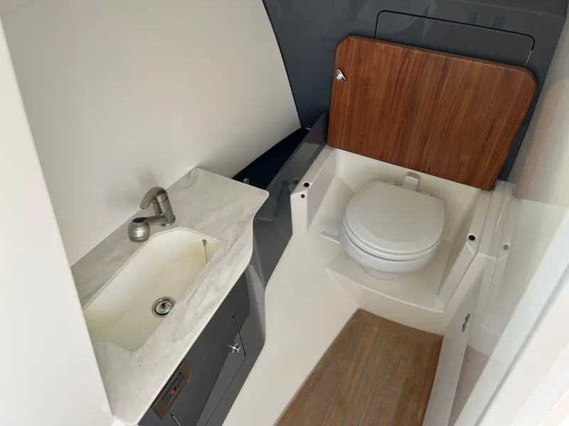 Slide: The Image of 2025 Boston Whaler 330 Vantage boat bathroom with sink and toilet. - 4