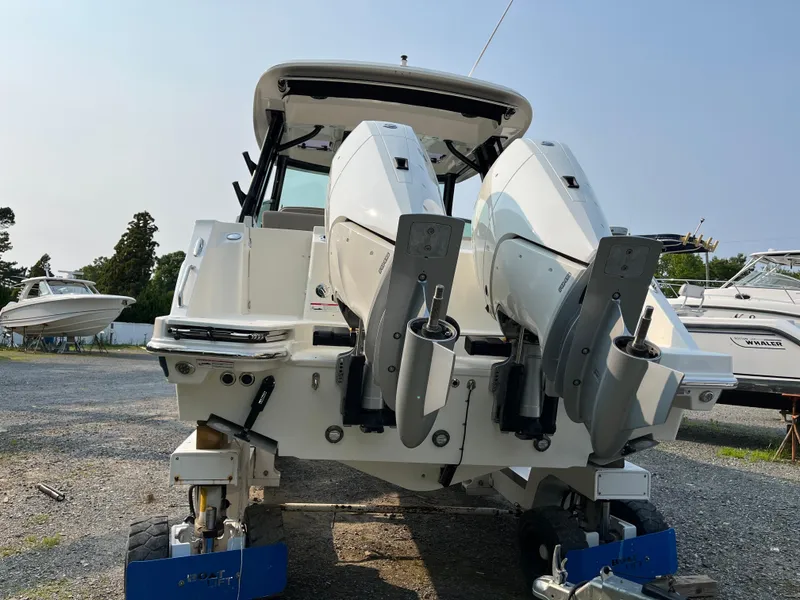 Slide: The Image of 2025 Boston Whaler 330 Vantage boat with dual outboard engines on display. - 42