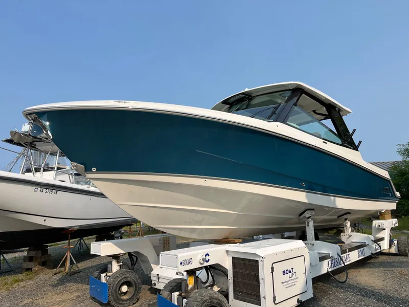Slide: The Image of 2025 Boston Whaler 330 Vantage boat on a trailer, side view. - 43