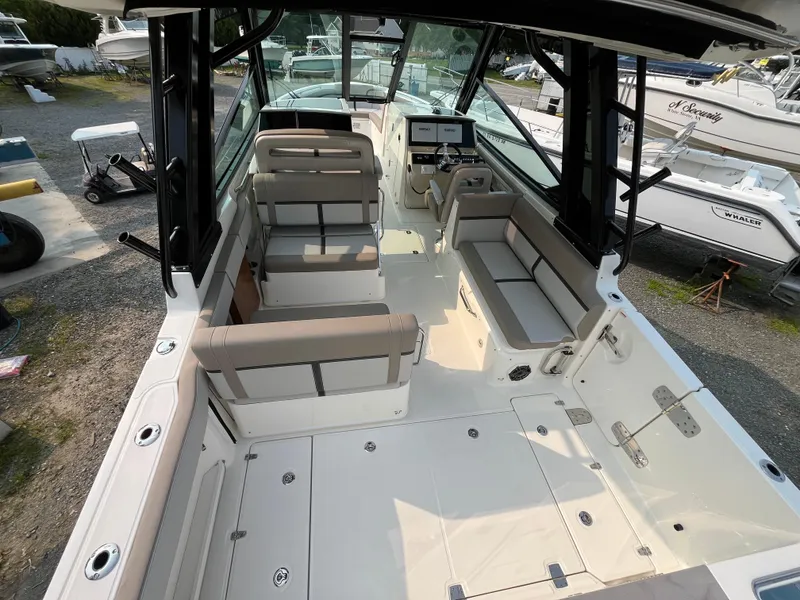 Slide: The Image of 2025 Boston Whaler 330 Vantage boat interior with seating and control panel. - 5