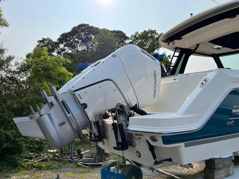 Slide: The Image of 2025 Boston Whaler 330 Vantage with Mercury outboard engine, docked outdoors. - 7