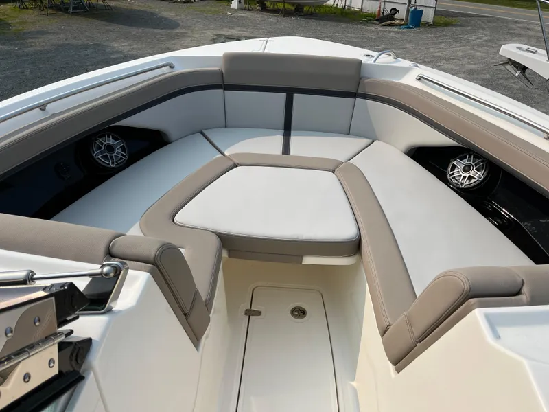 Slide: The Image of 2025 Boston Whaler 330 Vantage boat interior with cushioned seating and speakers. - 9