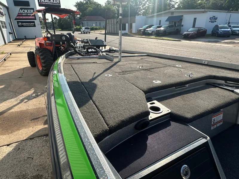 Slide: The Image of 2017 Nitro Z21 Z-Pro High Performance boat with green trim, parked outdoors. - 14