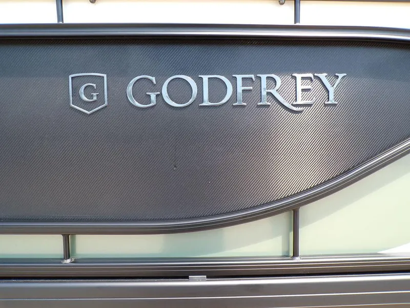 Slide: The Image of 2025 Godfrey Sweetwater 2286 SB boat logo on a sleek black panel. - 16