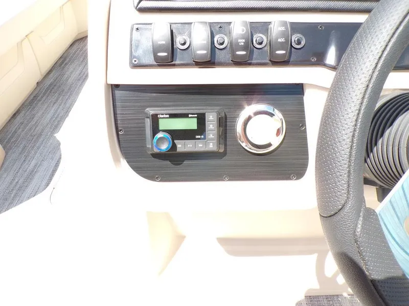 Slide: The Image of Control panel of 2025 Godfrey Sweetwater 2286 SB boat with audio system and switches. - 5