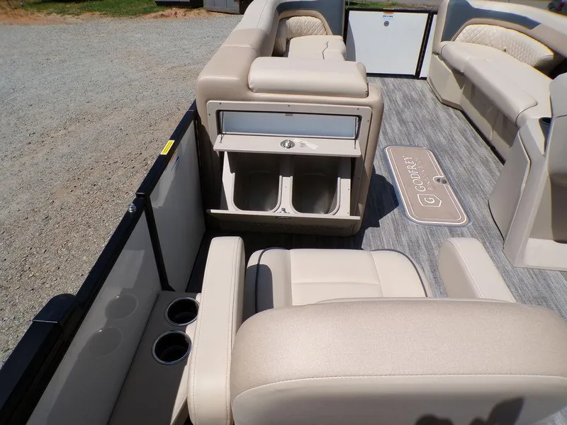 Slide: The Image of 2025 Godfrey Sweetwater 2286 SB boat interior with beige seating and storage compartments. - 6