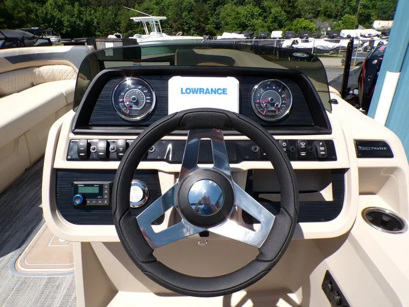 Slide: The Image of 2025 Godfrey Sweetwater 2286 SB boat dashboard with steering wheel and Lowrance display. - 7