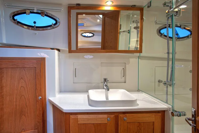 Slide: The Image of Luxurious bathroom in 2026 Back Cove 39O yacht with modern fixtures and wooden cabinetry. - 13