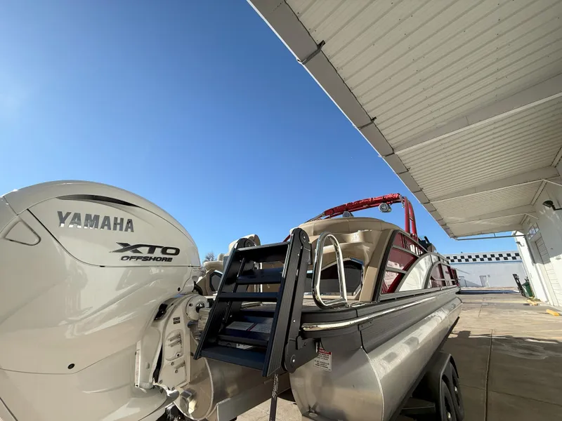 Slide: The Image of 2025 Bennington 25QXFB boat with Yamaha XTO engine under a canopy. - 15
