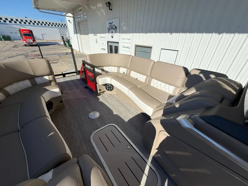 Slide: The Image of 2025 Bennington 25QXFB pontoon boat interior with beige seating and modern design. - 9