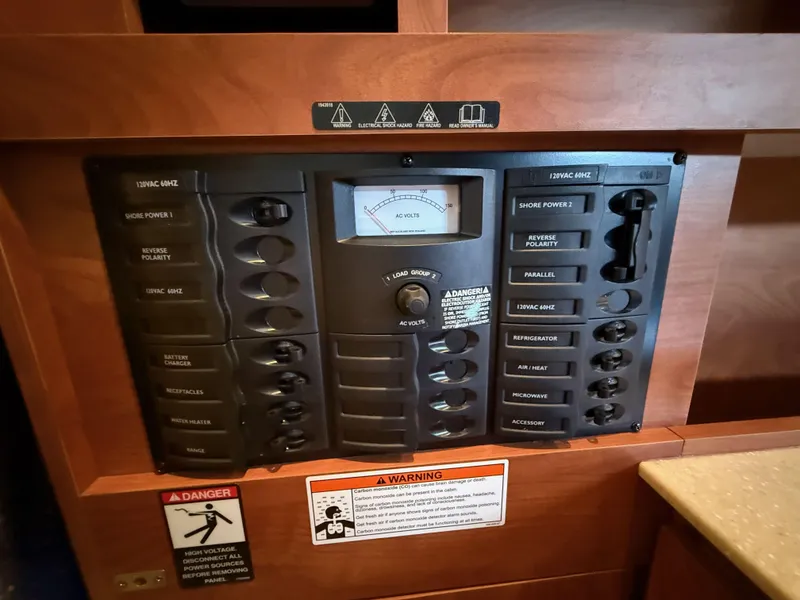 Slide: The Image of Control panel of a 2010 Bayliner 255 SB boat, featuring various switches and a voltage meter. - 19