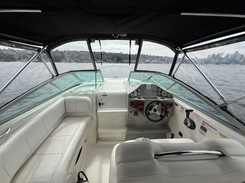 Slide: The Image of Interior view of 2010 Bayliner 255 SB boat cockpit with steering wheel and seating. - 4