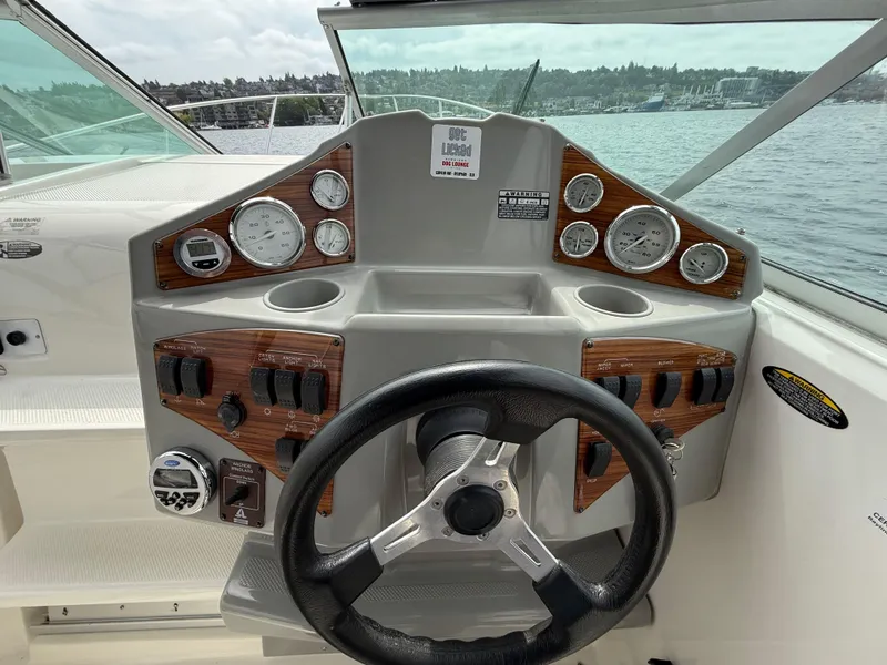 Slide: The Image of 2010 Bayliner 255 SB boat dashboard with steering wheel and instrument panel. - 7
