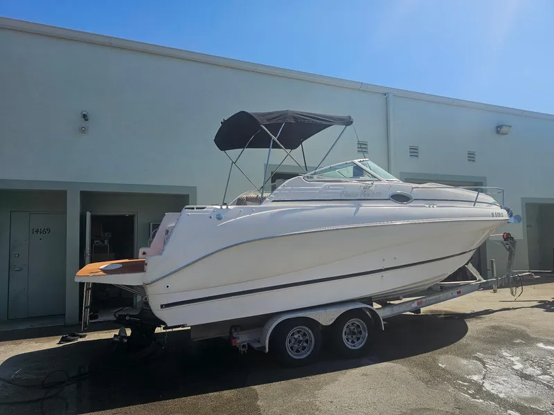 Slide: The Image of 2002 Rinker 242 Fiesta Vee boat on trailer, parked outdoors. - 1
