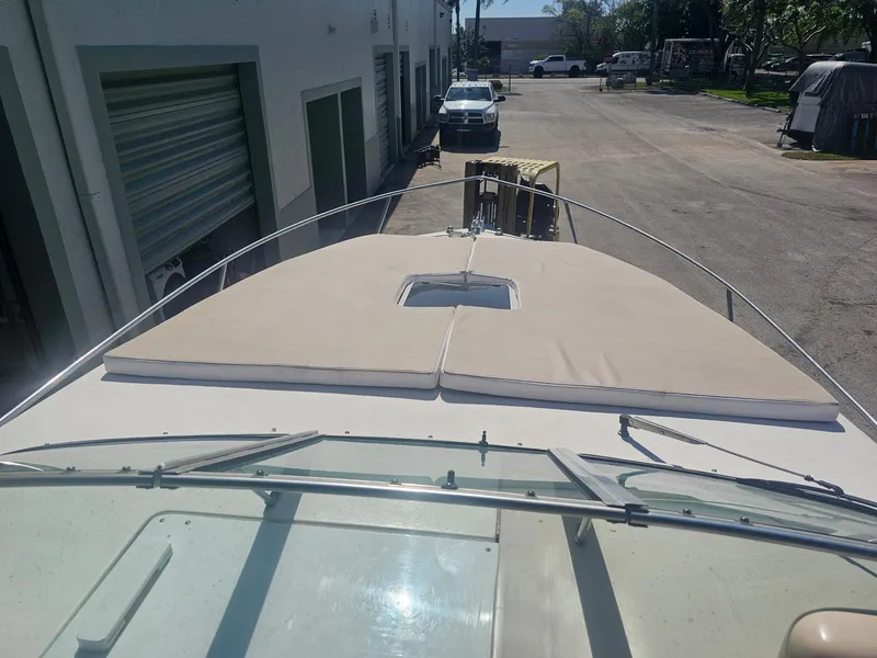 Slide: The Image of 2002 Rinker 242 Fiesta Vee boat docked in an industrial area. - 4