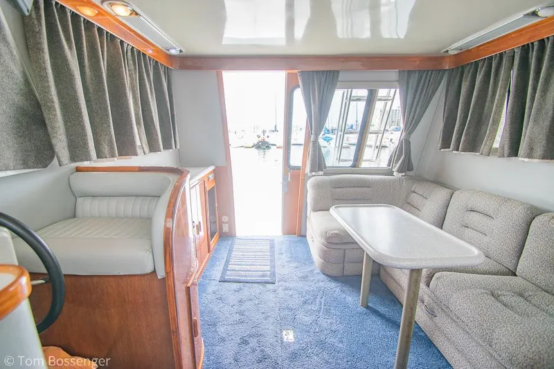 Slide: The Image of Interior of 1996 Mediterranean 38 Convertible yacht with plush seating and dining table. - 13