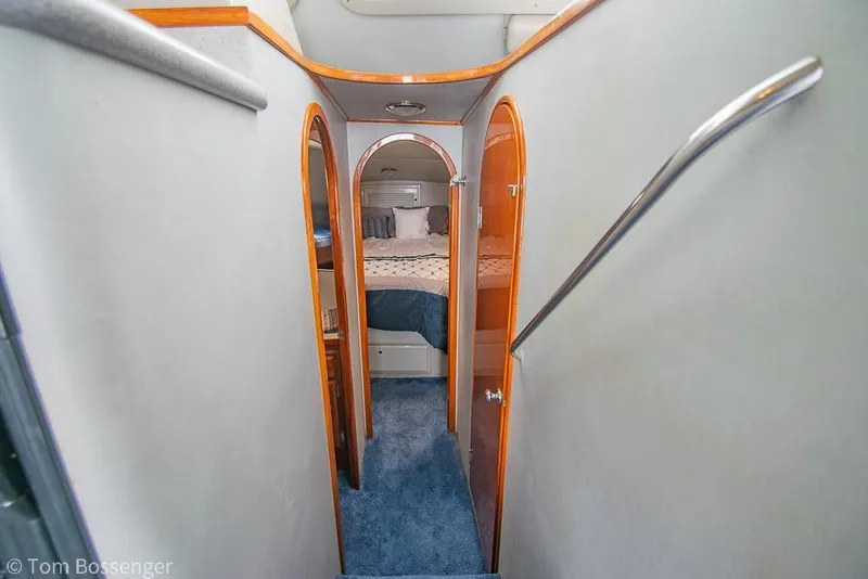 Slide: The Image of Interior hallway of 1996 Mediterranean 38 Convertible yacht with wood accents and blue carpet. - 14