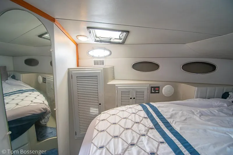 Slide: The Image of Cozy cabin interior of a 1996 Mediterranean 38 Convertible yacht with bed and storage. - 16