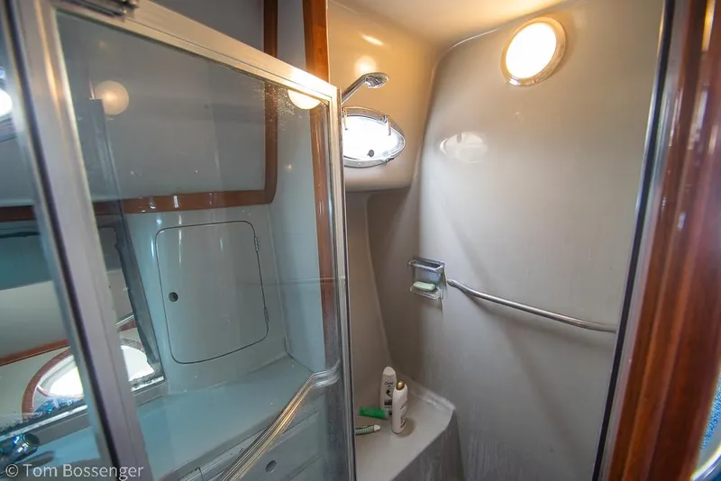 Slide: The Image of Bathroom interior of 1996 Mediterranean 38 Convertible yacht, featuring shower and porthole. - 19