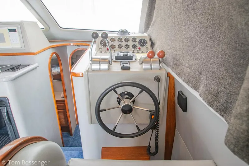 Slide: The Image of 1996 Mediterranean 38 Convertible yacht helm with steering wheel and control panel. - 20