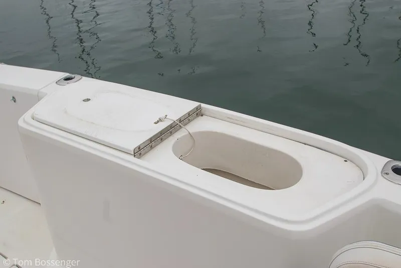 Slide: The Image of 1996 Mediterranean 38 Convertible boat deck with open storage compartment by the water. - 26
