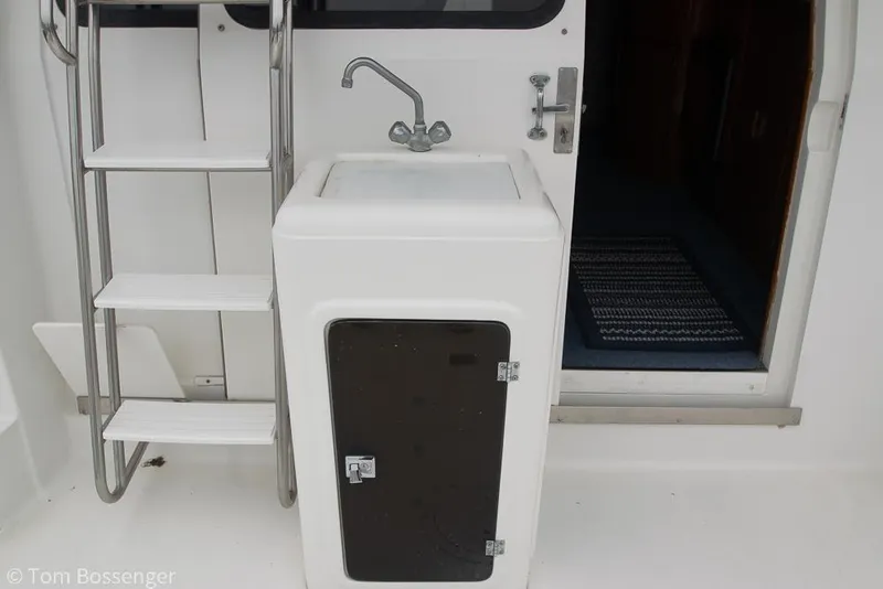 Slide: The Image of 1996 Mediterranean 38 Convertible yacht sink and ladder detail. - 27