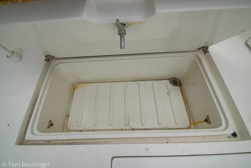 Slide: The Image of Open storage compartment on 1996 Mediterranean 38 Convertible boat, showing interior details. - 28