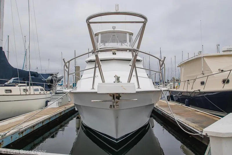 Slide: The Image of 1996 Mediterranean 38 Convertible yacht docked at marina, front view. - 3