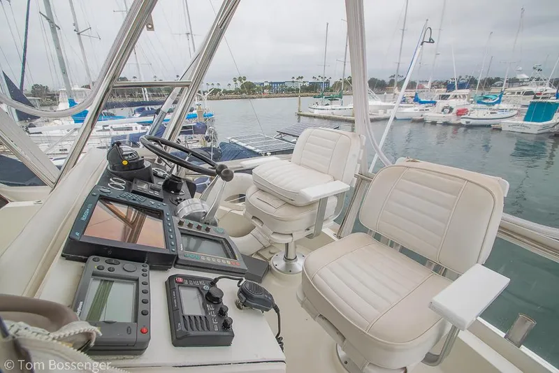 Slide: The Image of 1996 Mediterranean 38 Convertible yacht cockpit with navigation equipment and marina view. - 31