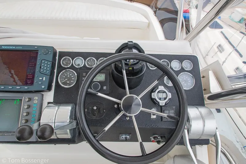 Slide: The Image of Control panel of a 1996 Mediterranean 38 Convertible boat with steering wheel and navigation instruments. - 34