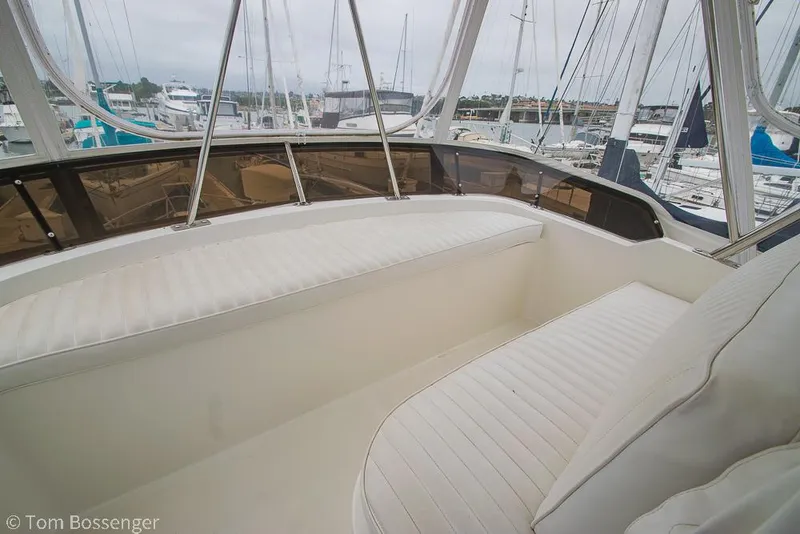 Slide: The Image of 1996 Mediterranean 38 Convertible yacht interior with white seating and marina view. - 35