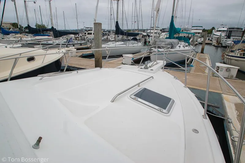 Slide: The Image of 1996 Mediterranean 38 Convertible yacht docked in a marina, surrounded by sailboats. - 38