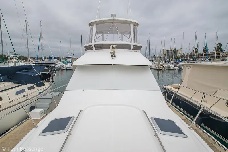 Slide: The Image of 1996 Mediterranean 38 Convertible yacht docked in a marina, surrounded by other boats. - 40