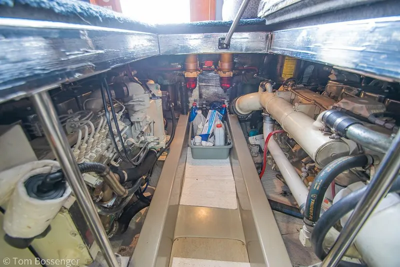 Slide: The Image of Engine room of a 1996 Mediterranean 38 Convertible boat, showcasing mechanical components. - 42