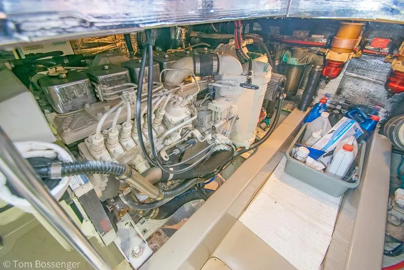 Slide: The Image of Engine room of a 1996 Mediterranean 38 Convertible boat, showcasing mechanical components and maintenance supplies. - 44