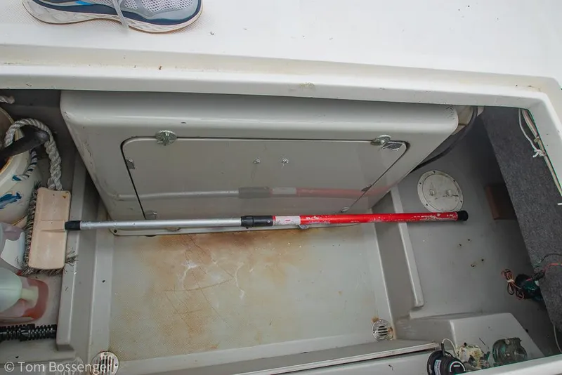 Slide: The Image of Storage compartment on a 1996 Mediterranean 38 Convertible boat with cleaning tools. - 45
