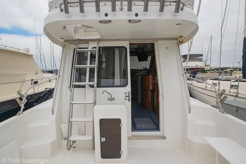 Slide: The Image of 1996 Mediterranean 38 Convertible yacht stern view with ladder and open cabin door. - 5