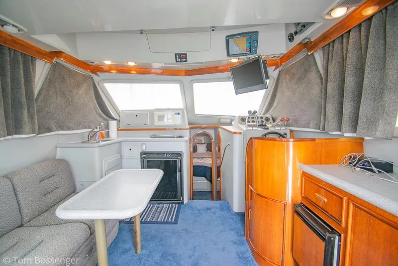 Slide: The Image of Interior of 1996 Mediterranean 38 Convertible yacht with modern amenities and cozy seating. - 6