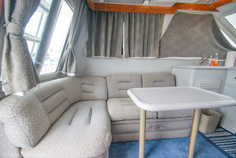 Slide: The Image of Interior of 1996 Mediterranean 38 Convertible yacht with gray seating and table. - 8