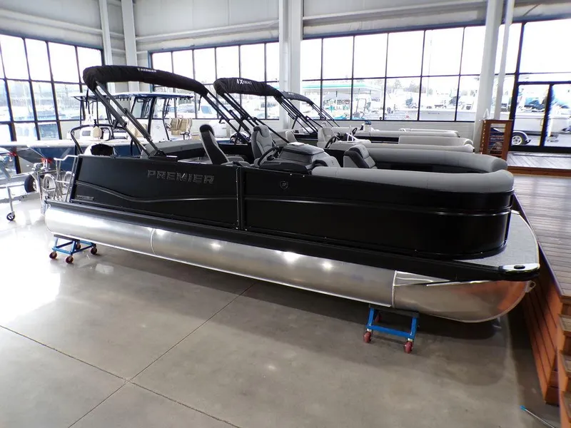The Image of 2025 Premier 230 Sunsation RL pontoon boat in showroom, sleek black design. - 0