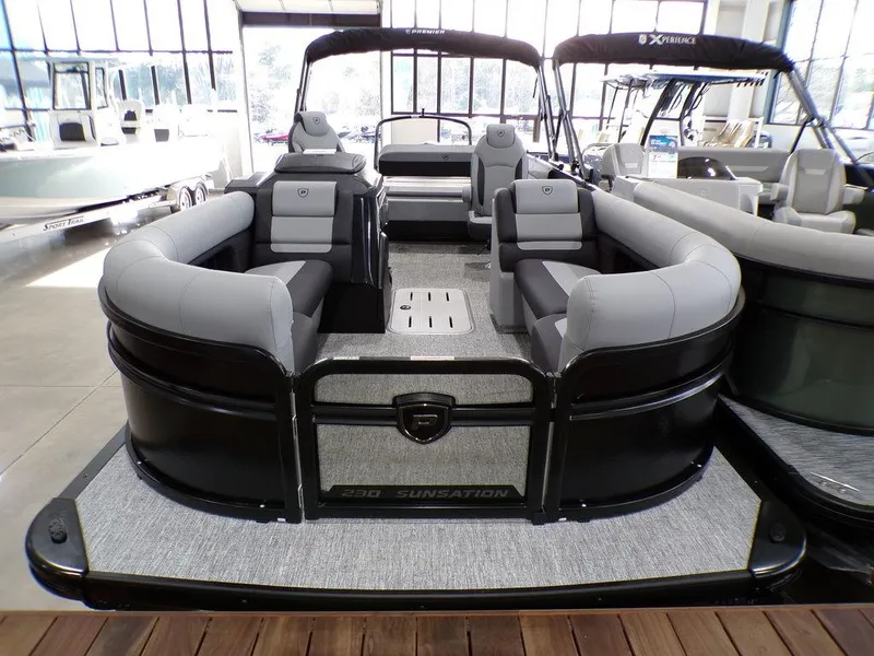 Slide: The Image of 2025 Premier 230 Sunsation RL pontoon boat with spacious seating in a showroom. - 20