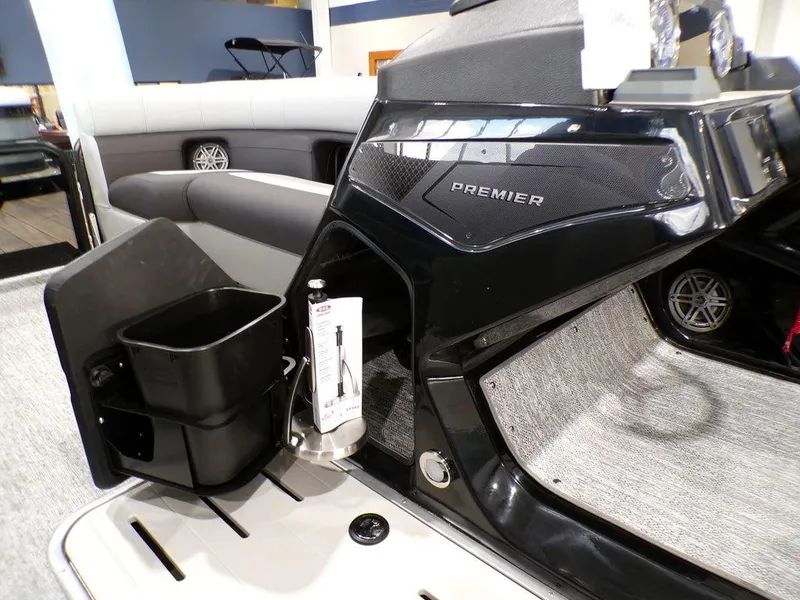 Slide: The Image of 2025 Premier 230 Sunsation RL boat interior with sleek black console and cup holder. - 3