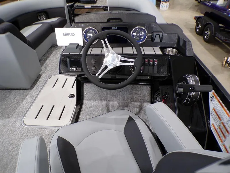 Slide: The Image of 2025 Premier 230 Sunsation RL boat interior with steering wheel and dashboard controls. - 9
