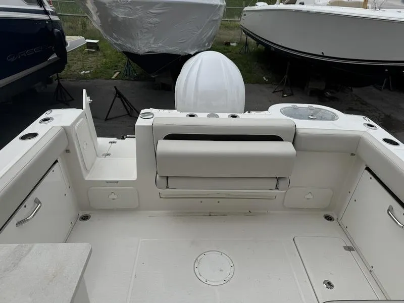 Slide: The Image of 2023 Sailfish 245 DC boat interior with white seating and storage compartments. - 3