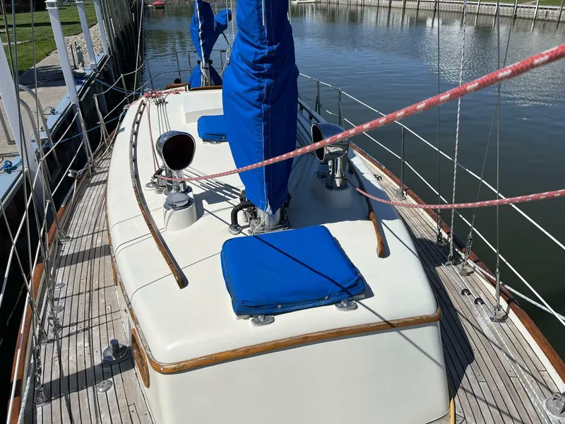 Slide: The Image of 1978 Cheoy Lee Offshore 33 sailboat deck with blue covers and wooden accents. - 10